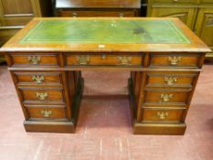 A GOOD OAK TWIN PEDESTAL DESK having a gilt tooled green leather insert over a three drawer frieze