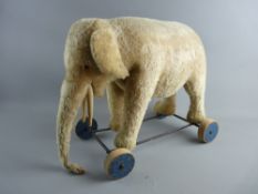 A VINTAGE STEIFF SIT-ON TOY ELEPHANT, ear tag, eyes and ring pull sound box intact but in well loved