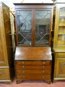 A CIRCA 1900 INLAID MAHOGANY BUREAU BOOKCASE having an inverted stepped cornice over twin thirteen