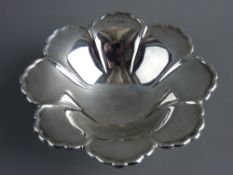 A PETAL SHAPED SILVER BOWL on a stepped circular base, 14 cms diameter, Birmingham 1962, 3.6 troy