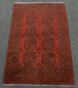 WASHED RED AFGAN DOUBLE KNOT RUG with traditional Bukhari design, 123 x 179cms