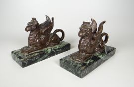 A PAIR OF BRONZE GRYPHON SPILL VASES on rectangular veined marble bases, 14cms wide
