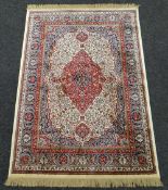 IVORY GROUND KASHMIR RUG with traditional medallion design, 136 x 194cms