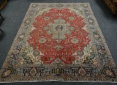 A LARGE RED GROUND PERSIAN TABRIZ CARPET, 256 x 335cms