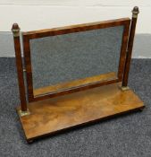 A GEORGIAN FLAME MAHOGANY TOILET MIRROR with brass mounts & on bun feet, 79cms wide