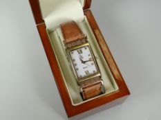 A 'CLOGAU' AUTOMATIC WRIST WATCH with original case and having 9ct yellow gold lugs, tan leather