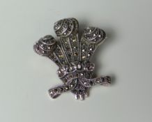 A STERLING SILVER & MARCASITE BROOCH IN THE FORM OF PRINCE OF WALES FEATHERS, marked 925, 3cms high