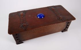 AN ARTS & CRAFTS COPPER CASKET riveted with a hammered finish, having oversize Gothic hinges and a