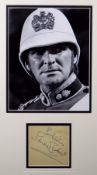 STANLEY BAKER autograph with 'Best Wishes' on paper and framed together with a still photograph