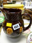 A Doulton Kingsware water jug with depictions of Dickens characters, Sam Weller, Pickwick, Sydney