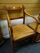 An antique early twentieth century mahogany railback hall armchair