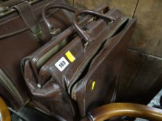 A tan leather vintage doctor's appointment case