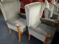 A pair of modern pale green velour upholstered wood framed wingback armchairs