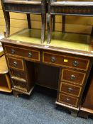 A neat reproduction mahogany leather tool topped desk of small proportions with bank of drawers to