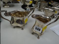 A hallmarked silver milk jug, sugar bowl together with a hallmarked silver long handled spoon