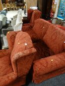 A good quality lounge suite comprising two-seater sofa, two wingback armchairs in a red two-tone