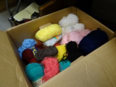 A box of various coloured knitting wool