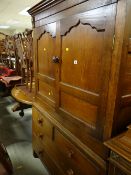A nineteenth century Welsh oak linen cupboard with a base of two long & two short drawers