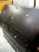 A four-drawer sloped bureau