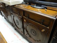 A carved two-door & two-drawer vintage oak sideboard