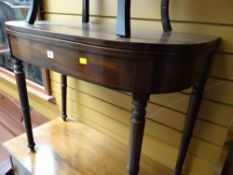 An antique foldover tea table