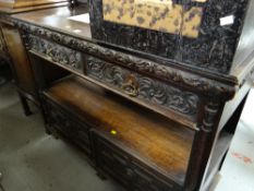 An antique carved two-drawer buffet sideboard