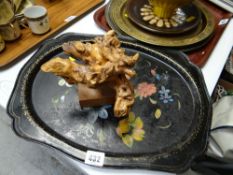 A small decorated Pontypool-style metal tray together with a small driftwood sculpture