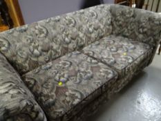 A two-seater floral upholstered Chesterfield-style foldout bed settee