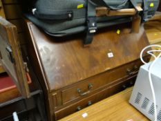 A vintage three-drawer slope fronted bureau