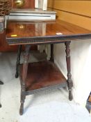 An antique two-tier mahogany square based coffee table
