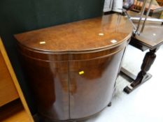 A vintage polished demi-lune sideboard