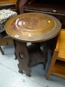 A copper top pub table with lower tier in an Arts & Crafts-style