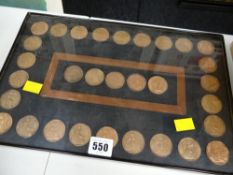A wall mounting display set of early twentieth century pennies from Queen Victoria to Elizabeth II