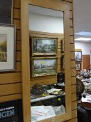 A modern lightwood framed hall mirror