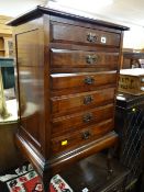 A six-drawer mahogany music cabinet