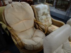 A cushion seated rattan conservatory chair together with a similar bamboo cushioned rocking chair