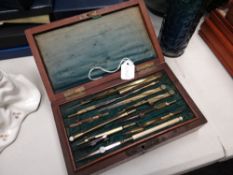 A vintage cased set of technical drawing instruments