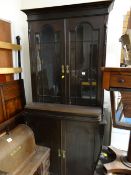 A stained early twentieth century bookcase cupboard