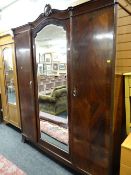 A large early twentieth century mahogany two-door wardrobe with centre mirror