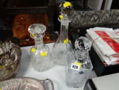 Three decanters including Edinburgh crystal