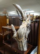 A carved driftwood owl