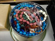 Tin of costume jewellery, necklaces