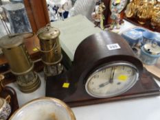 A vintage Napoleon hat mahogany mantel clock together with two reproduction miners lamps