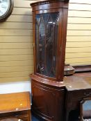 A reproduction mahogany glazed top standing corner cupboard