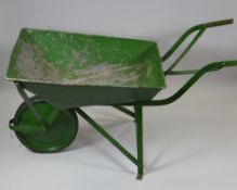 A GREEN PAINTED METAL VINTAGE WHEELBARROW with rubber tyre wheel (BBC Bargain Hunt)