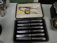 A cased set of six hallmarked silver handled tea knives, sugar tongs etc
