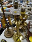 A brass & clear glass oil lamp base together with another brass oil lamp base, brass table lamp