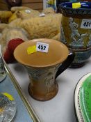 A rare Doulton Lambeth single-handled beaker with decorated raised relief of cyclists & embossed