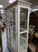 A good modern two-door glazed display cabinet with base drawer