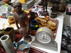 A modern London Clock Company dome top mantel clock together with a carved tribal figure